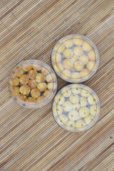 Three Containers of Assorted Indonesian Cookies on Bamboo Mat
