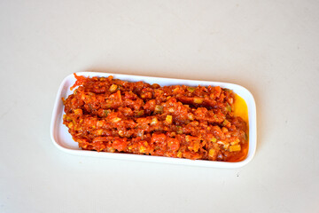 A spicy Turkish appetizer ezme made with tomatoes, bell pepper, parsley, mint, olive oil and hot chili. A kind of adjika. Kahvaltilik acuka, Antep usulu acili ezme.