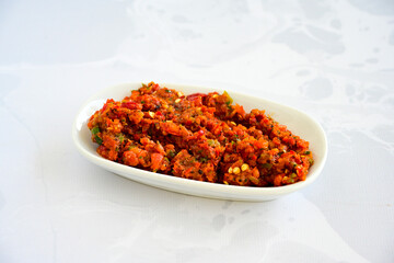 A spicy Turkish appetizer ezme made with tomatoes, bell pepper, parsley, mint, olive oil and hot chili. A kind of adjika. Kahvaltilik acuka, Antep usulu acili ezme.