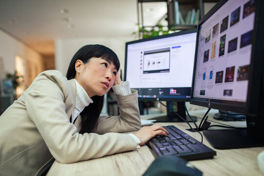 Exhausted businesswoman working late at office desk