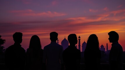 Fototapeta premium Silhouetted Figures Against Indian Landmarks at Sunset Symbolizing Youth and Aspirations for the Future