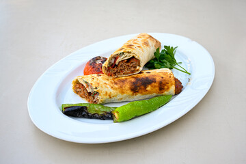 Grilled Turkish Adana, Urfa  Kebab with grilled vegetables, onion and rice on plate. Adana durum, Urfa durum .