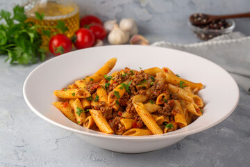 Penne pasta with minced meat and tomato sauce