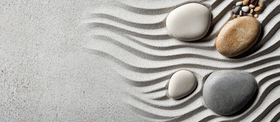 Obraz premium Serene minimalist Zen rock garden featuring smooth pebbles arranged in wave patterns with ample space for text placement.