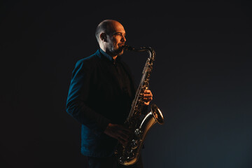 Naklejka premium Saxophonist in Spotlight Creating Melodic Harmony