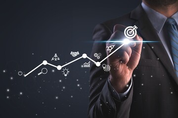 The 2025 business goals. Businessman touching arrow graph