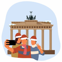Friends take selfies near theBrandenburg Gate   on Christmas. © Svutlana