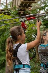 Two children gear up for an exhilarating zipline adventure in a lush forest setting, surrounded by trees and vibrant nature, full of thrill and laughter.