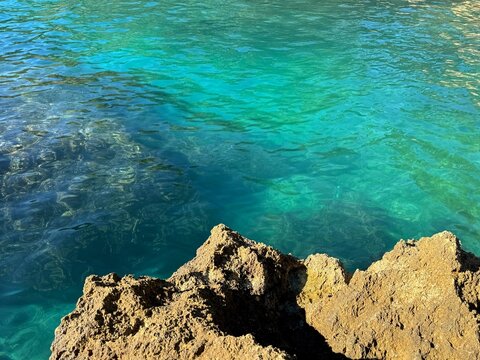 Clear sea green water and rocks.