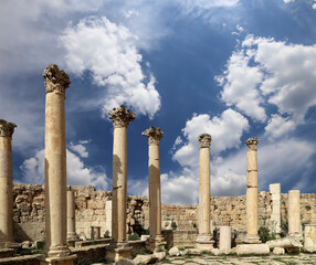 Roman Columns in the Jordanian city of Jerash (Gerasa of Antiquity), capital and largest city of Jerash Governorate, Jordan. Against the background of a beautiful sky with clouds