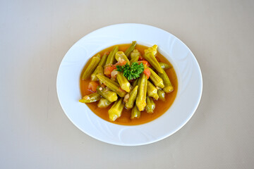 Bamya, Turkish traditional food. (Turkish cuisine) Homemade Food Okra in Plate. Organic Food. Etli bamya yemegi. 