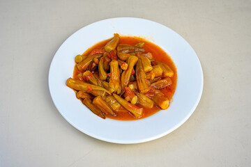 Bamya, Turkish traditional food. (Turkish cuisine) Homemade Food Okra in Plate. Organic Food. Etli bamya yemegi. 