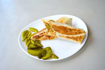 Lavash doner kebab ( soslu kasarli zurna doner durum )  or shawarma sliced in plate isolated.  Tavuk Et Doner Durum. Hatay Iskenderun usulu bazuka tavuk doner durum.