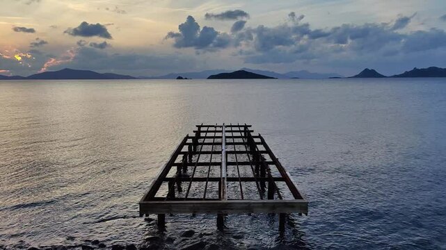 Old abandoned wooden fishing pier on the sea in the countryside. vertical video for social media. 