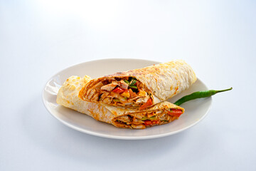 Lavash doner kebab ( soslu kasarli zurna doner durum )  or shawarma sliced in plate isolated.  Tavuk Et Doner Durum. Hatay Iskenderun usulu bazuka tavuk doner durum.