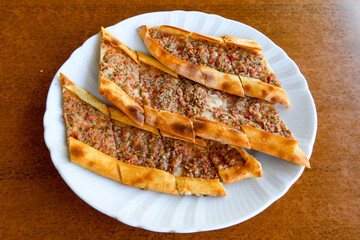 Kiymali pide.Turkish pide with minced meat. Turkish pizza mince pita Pide on white . Etli ekmek.Kusbasi kasarli, kiymali kasarli, kiymali yumurtali, Bafra, Trabzon, Kusbasili pide. Urfa acili lahmacun