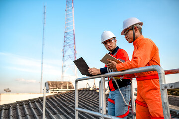 A solar panel maintenance and installer is checking the operation of an electrical circuit on a laptop. to check accuracy before working