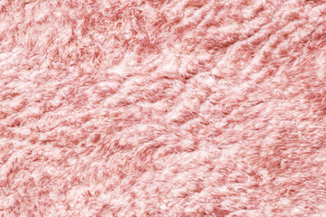 Soft and fluffy carpet texture. Fibers pattern. Cozy fabric closeup background. Plush material pink color. Comfort and softness backdrop. Premium wool fur canvas macro.