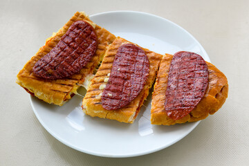 Turkish karisik atom kare  tost ( kasarli bazlama tost) . Sucuklu, Kasarli,  cheddarli, kavurmali karisik tost. Flat baked bread toasted. Karisik bazlama tost .