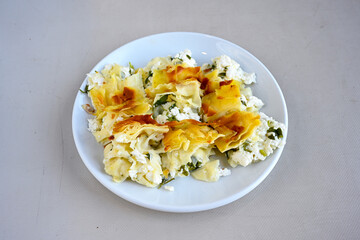 Turkish style meat stuffed filo dough borek served kol boregi.Cheese and minced pie are sliced on a marble background. Turkish name: Kol Boregi, kiymali, peynirli su boregi. Ci borek. Kafkas cig borek