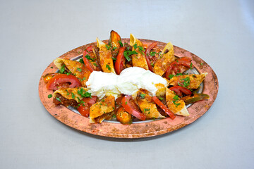 Famous Urfa meat liver, ciger wrapped by lavash with roasted chili pepper, onion and sauce in...