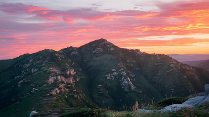Obraz premium A photo of a mountain range during sunset.