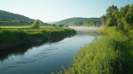Obraz premium Peaceful River Landscape with Lush Green Banks and Morning Mist