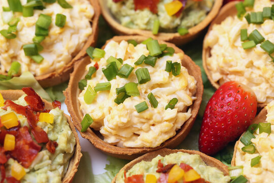 Egg paste cupcake. Egg spread tartlets. Boiles eggs with mayo on baked tarta cake sprinkled with chives onion spring. Salty party snack. Eggs salad on tartlet. Savory party snack featuring egg salad.