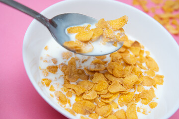 Top View of Cereal with Milk on Pink Background - Flat Lay of a Sweet Breakfast Delight