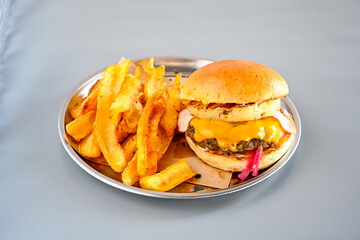Big tasty burger with beef cutlet on a plate. Hamburger, cheeseburger with mushroom. Hamburger, Mexica, mushroom double cheddar  burger.  Crispy chicken burger. With french fries, patates kizartmasi.
