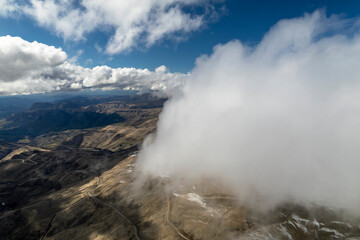Low clouds in the mountains. Aerial view of low fog in mountainous area
