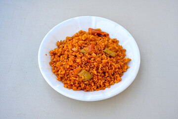 Traditional turkish bulgur pilaf with tomato sause in plate (Turkish name; bulgur pilavi, meyhane pilavi)