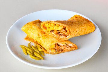 Lavash doner kebab ( soslu kasarli zurna doner durum )  or shawarma sliced in plate isolated.  Tavuk Et Doner Durum. Hatay Iskenderun usulu bazuka tavuk doner durum.