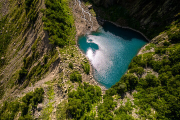 Mountain lake with blue water in a picturesque gorge. Landscape and nature of the North Caucasus