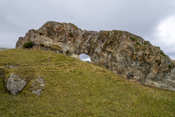 Rock arch. A mountain range with a through arch. Landscape and nature of the North Caucasus