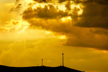 Golden Sky Sunset or Sunrise with Radio Tower on Hill Top