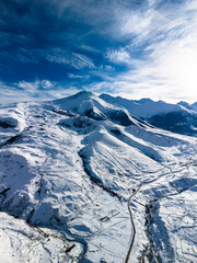 Beautiful aerial view of snowy peaks in a picturesque gorge. Landscape and nature of the North Caucasus