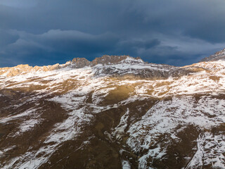 Beautiful aerial view of snowy peaks in a picturesque gorge. Landscape and nature of the North Caucasus