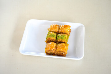 Turkish Dessert Sobiyet, havuc dilimi, midye baklava, mussels baklava and classic baklava with Pistachio . Cikolatali cevizli, fistikli soguk Baklava, top view.