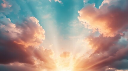 Obraz premium A stunning sunrise illuminates the sky with vibrant colors, casting rays through fluffy clouds, creating a serene and breathtaking atmosphere.