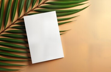 Blank greeting invitation card mockup with tropical palm leaf decorations on beige background. Empty card provides space for custom design text. Flat lay view highlights natural elements, stylish