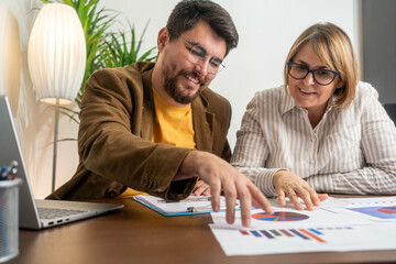 Business colleagues using digital tablet at desk in office. Business people, meeting and talking or...