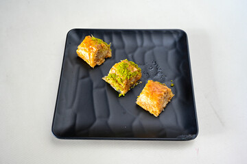 Turkish Dessert Sobiyet, havuc dilimi, midye baklava, mussels baklava and classic baklava with Pistachio . Cikolatali cevizli, fistikli soguk Baklava, top view.