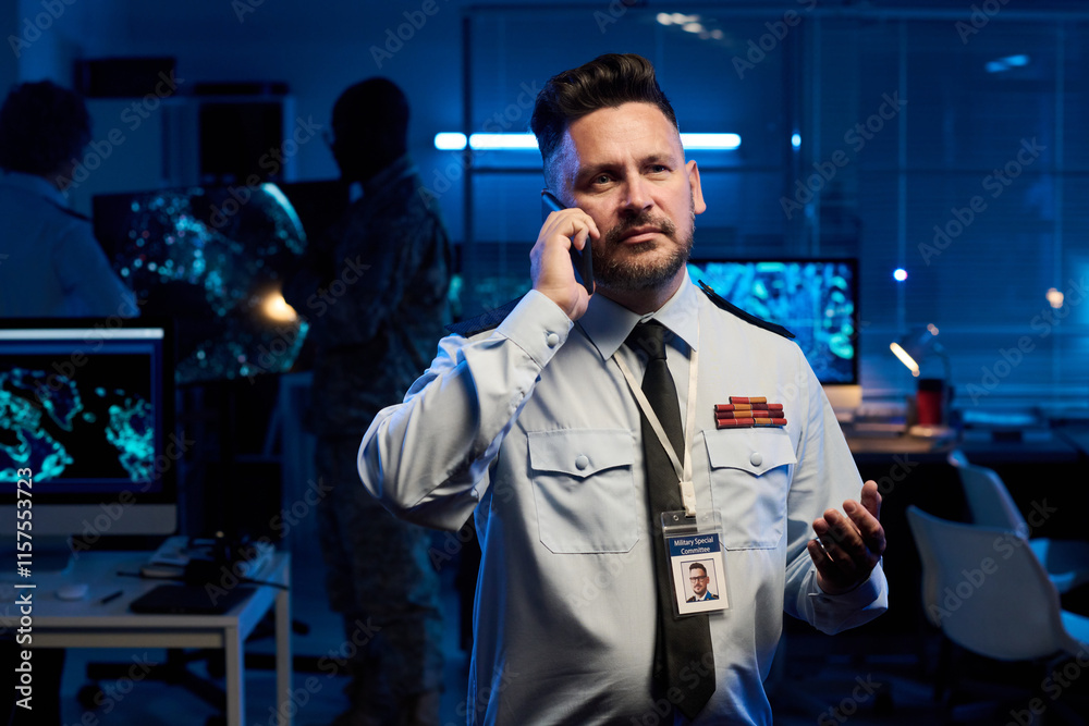 Aufkleber confident mature male officer standing in front of camera in military command center and talking on 