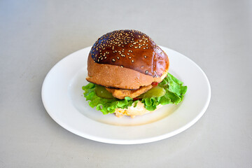 Big tasty burger with beef cutlet on a plate. Hamburger, cheeseburger with mushroom. Hamburger, Mexica, mushroom double cheddar  burger.  Crispy chicken burger. With french fries, patates kizartmasi.