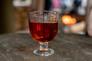 glass of red drink wine on wooden table