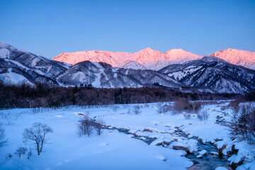 Winter landscape of the mountain stream. Snow-covered stream in Hakuba, Japan.