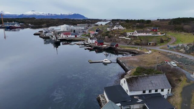 Drone view of seaside buildings with the BOAS facility surrounding the water in Averoy, Norway