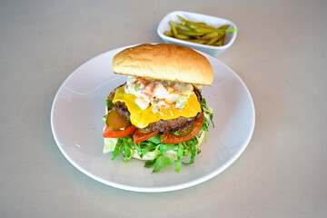 Big tasty burger with beef cutlet on a plate. Hamburger, cheeseburger with mushroom. Hamburger, Mexica, mushroom double cheddar  burger.  Crispy chicken burger. With french fries, patates kizartmasi.