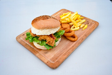 Big tasty burger with beef cutlet on a plate. Hamburger, cheeseburger with mushroom. Hamburger, Mexica, mushroom double cheddar  burger.  Crispy chicken burger. With french fries, patates kizartmasi.